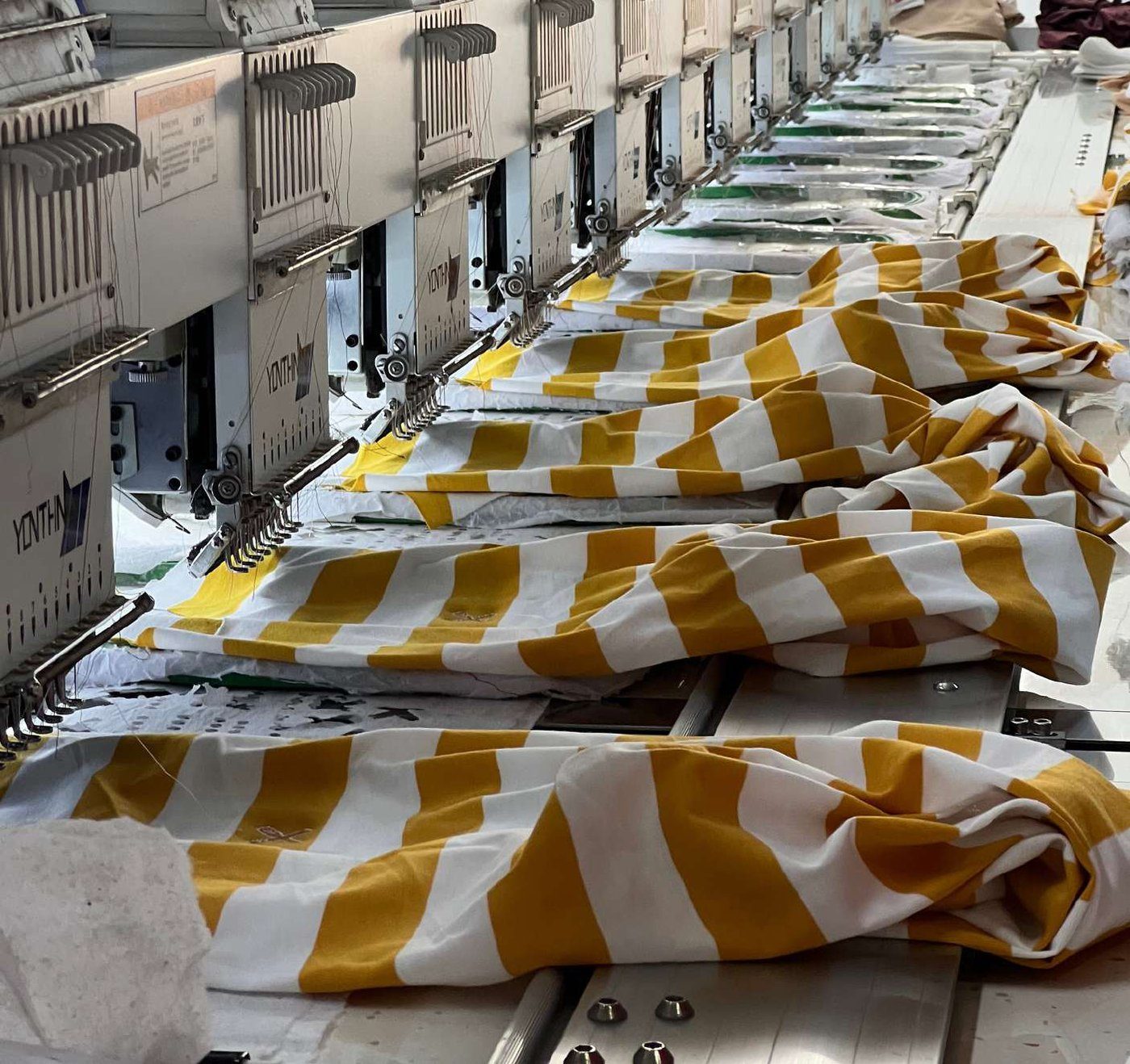 Embroidery machines finishing striped fabric